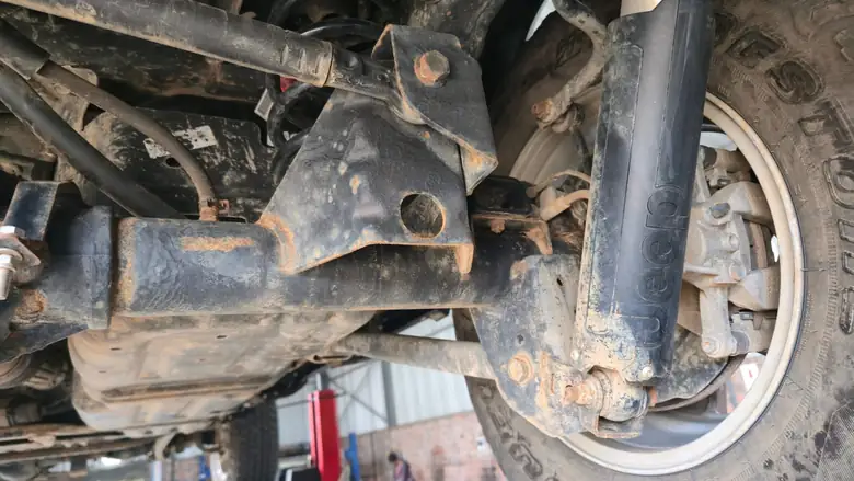 Rear axle and shock mount before treatment
