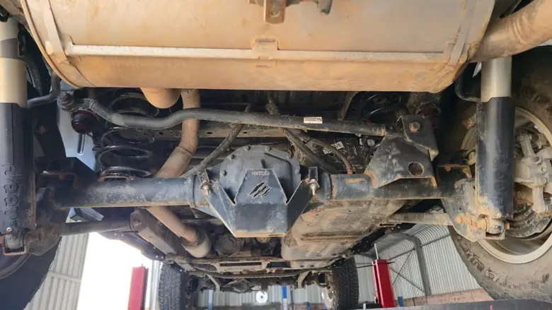 Rear underbody on arrival — axle, coils, sway bar and shock mounts all going the same way